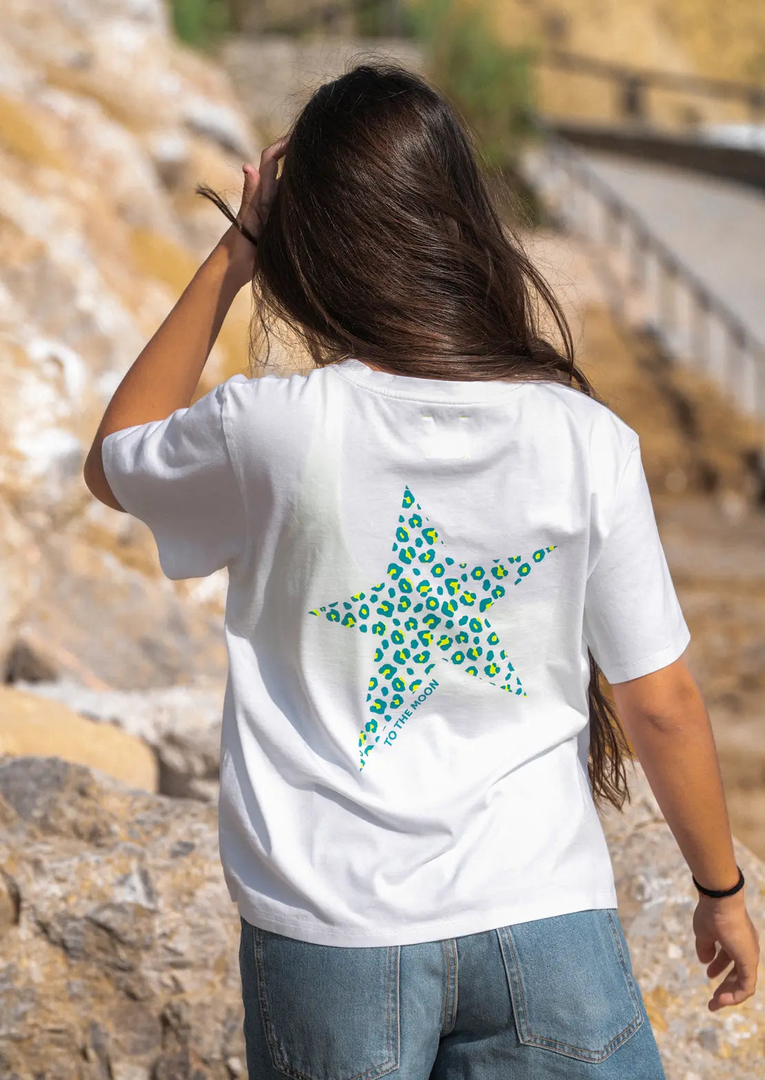 Espalda de Camiseta manga corta de To the Moon en color blanco con estampado estrella animal print y amarillo flúor en azul aqua